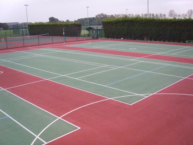 Tennis courts on top of red and green colour coat